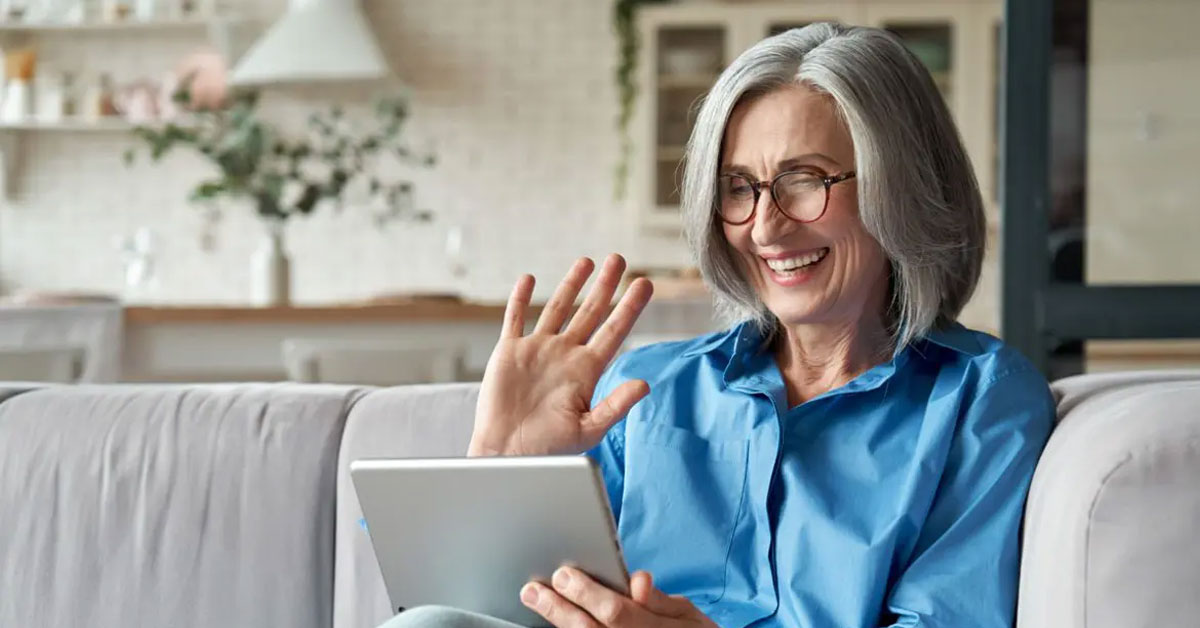 Senior woman in South Burnett using a tablet for a telehealth consultation at home